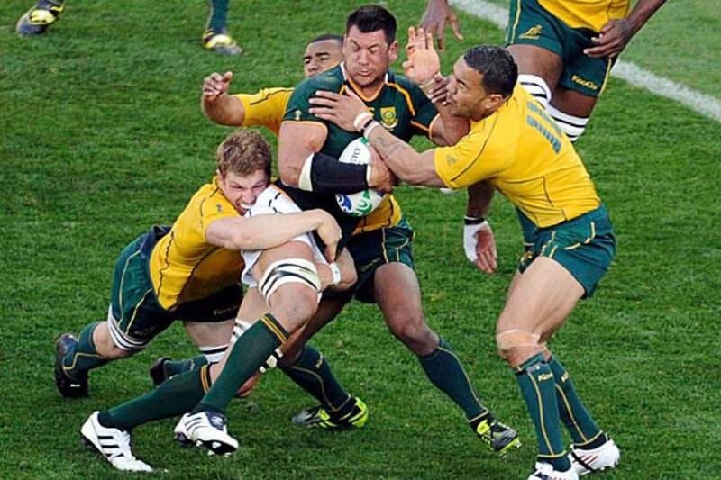 Pierre Spies, the South African flanker, is swamped by three Australian tacklers during the Wallabies 11-9 Rugby World Cup quarter-final win.

Anthony Phelps / Reuters