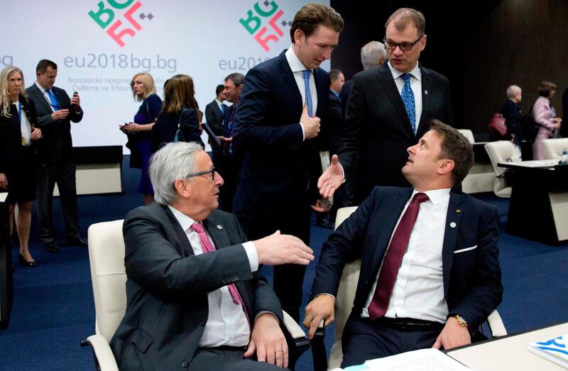 Austrian Chancellor Sebastian Kurz (rear left) and Finnish Prime Minister Juha Sipila (rear right) speak with European Commission President Jean-Claude Juncker (left) and Luxembourg's Prime Minister Xavier Bettel during a round table meeting of EU and Western Balkan heads of state at the National Palace of Culture in Sofia on May 17, 2018.  Virginia Mayo / AFP