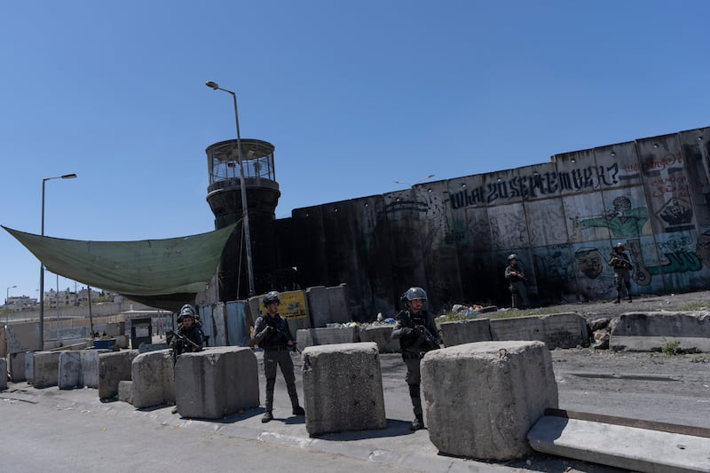 Israeli Border Police secure the perimeter of the closed Israeli army Qalandia checkpoint, used by Palestinians to cross from the West Bank into Jerusalem, near the West Bank city of Ramallah.  AP Photo
