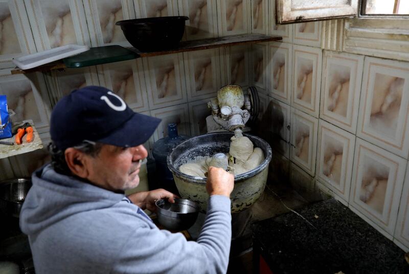 Abu Shadi operates the kneading machine at his bakery in the Ras Beirut area of Beirut. AFP
