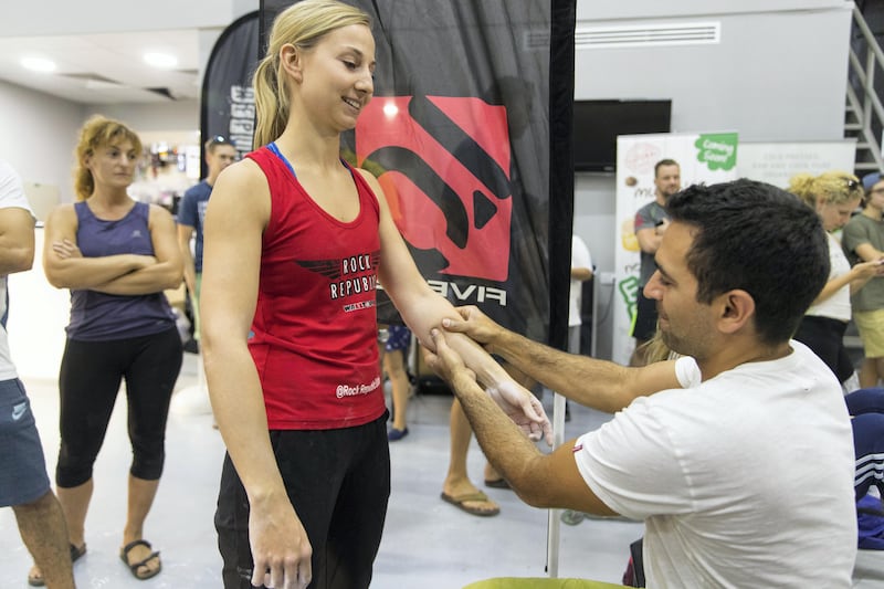Dubai, United Arab Emirates, August 26, 2017:  Georgio Akiki  of Lebanon massages the forearms of Carina Ganahl of Austria during the finals of the  Boulder Bash climbing competition at Rock Republic climbing gym in the Dubai Investment Park area of Dubai on August 26, 2017. Ganahl placed second in the female division. Bouldering is a form of climbing, that has no ropes, but focuses on very physical and technical problems closer to the ground and is one of the three disciplines that will be included in the 2020 Olympics. Christopher Pike / The National

Reporter: Roberta Pennington
Section: News