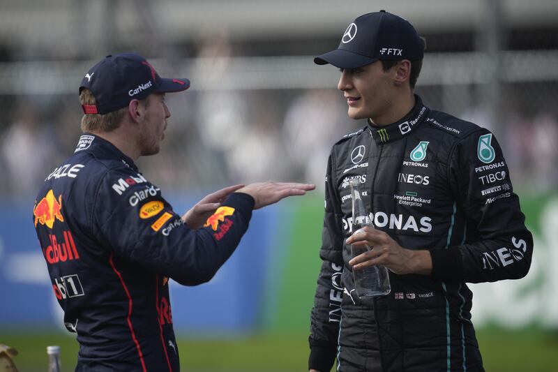 George Russell and Max Verstappen speak after the qualifying session. EPA