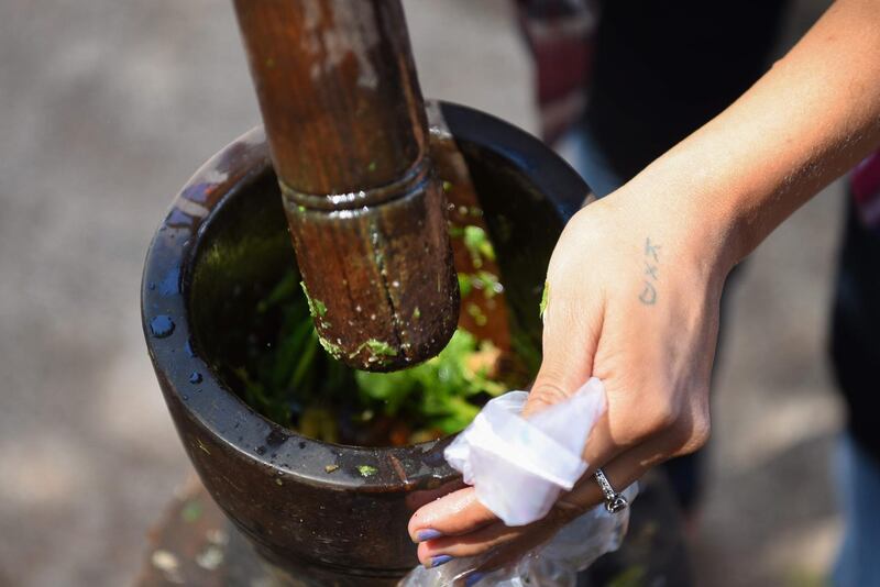 The drink is prepared in a jug or thermos, in which cold water is mixed with medicinal herbs crushed in a mortar. AFP