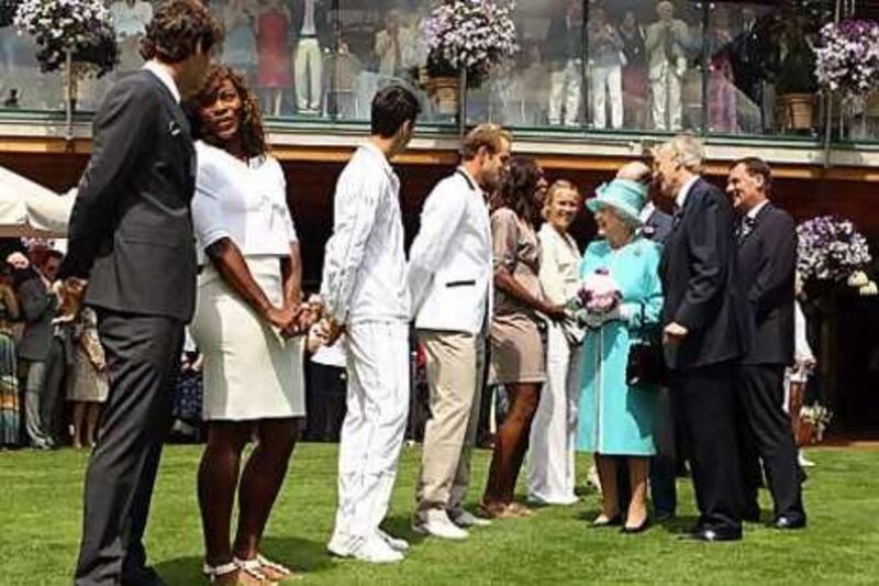 Britain's Queen Elizabeth II  meets, from left, Roger Federer, Serena Williams, Novak Djokovic, Andy Roddick, Venus Williams and Caroline Wozniacki as she attends the Wimbledon .for the first time in 33 years.