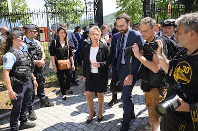 French Prime Minister Elisabeth Borne, centre, speaks to the press after the attack. EPA
