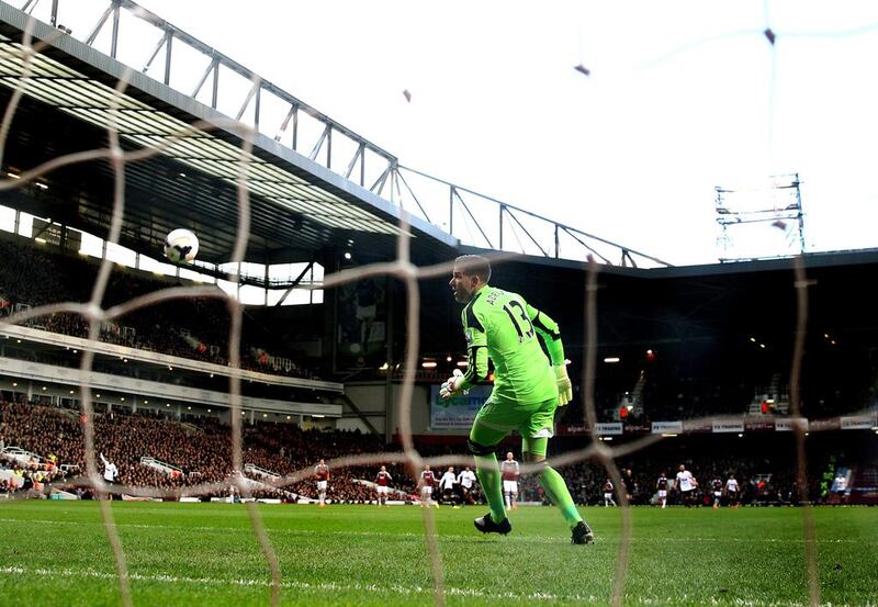 Goalkeeper Adrian of West Ham looks on in vain as the long range shot from Wayne Rooney of Manchester United opens the scoring during their match at Boleyn Ground on Saturday. Julian Finney / Getty Images / March 22, 2014