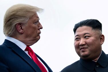 (FILES) This file photo taken on June 30, 2019 shows US President Donald Trump and North Korea's leader Kim Jong Un talking before a meeting in the Demilitarized Zone(DMZ) in Panmunjom.  - When he inherited power in North Korea 10 years ago, Swiss-educated basketball fan Kim Jong Un seemed open to foreign ideas and market reforms, but is increasingly shutting down outside influences as he enters his second decade in office.  (Photo by Brendan Smialowski  /  AFP)  /  TO GO WITH NKorea-Kim-politics-economy-culture,FOCUS by Sunghee Hwang