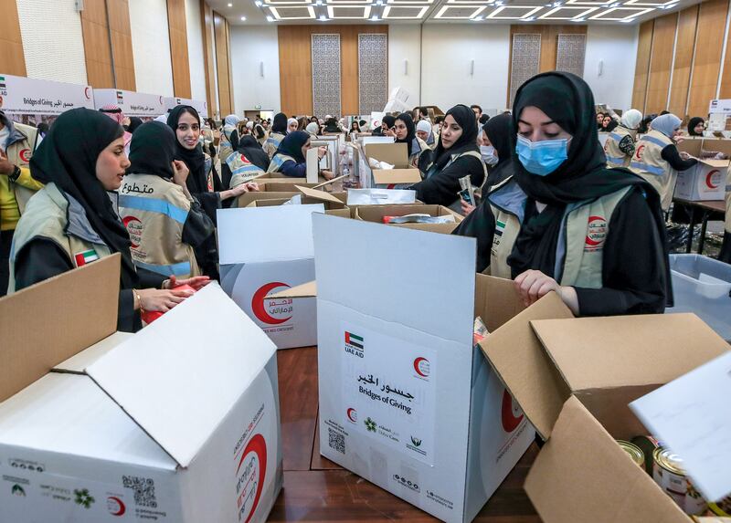 Workers with the Emirates Red Crescent Bridges of Goodness campaign prepare aid for earthquake-ravaged Turkey and Syria at Adnec in Abu Dhabi. Victor Besa / The National