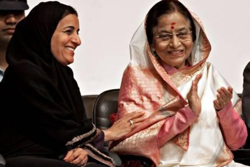 Abu Dhabi, November 23, 2010 - Indian President Pratibha Devisingh Patil (R) shares a lighter moment with H.E. Sheikha Lubna bint Khalid bin Sultan Al Qasimi (L) the UAE's Minister of Foreign Trade during a ceremony at the Indian School in Abu Dhabi, November 23, 2010. (Jeff Topping/The National) 