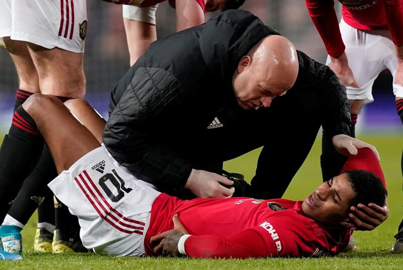 Manchester United's Marcus Rashford receives medical attention after sustaining an injury. Reuters