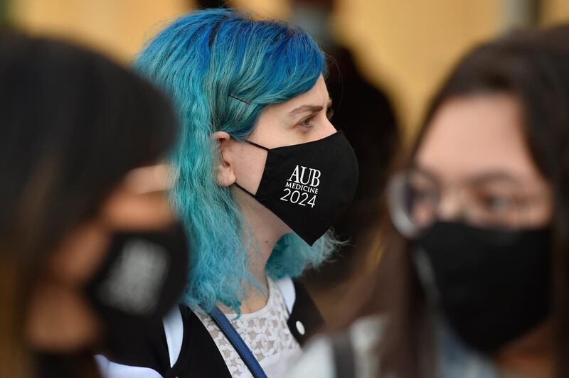 Medical students at the American University of Beirut (AUB) wear face masks as they attend a protest against the adjustment of the dollar rate for new tuition fees in Beirut, Lebanon. EPA