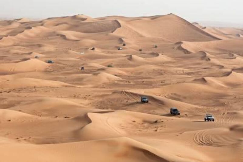 Sharjah, July 29, 2011 - Drivers make their way across the dunes a few kilometers off the Hatta/Oman road and 70 kilometers east of Dubai near the village of Tawi Nizwa, Sharjah, July 29, 2011. (Jeff Topping/The National) 