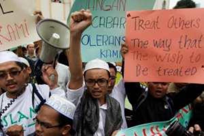 epa01982932 Malaysian muslims protest against a court ruling allowing Christians to use the word Allah outside the Kampung Baru Mosque after friday prayer in Kuala Lumpur, Malaysia 08 January 2009.Three Malaysian churches were attacked 08 January with firebombs, while at least two others received threats by phone, ahead of a Muslim protest against a court ruling allowing Christians to use the word Allah, church leaders said. Several Muslim groups gathered at three major mosques around the capital to protest a High-Court ruling last week that allowed the Herald, Malaysiaës main Roman Catholic newsletter, to use Allah, which is the Arabic word for God. The government had ruled last year that the word could not be used in non-Muslim publications.  EPA/AHMAD YUSNI *** Local Caption ***  01982932.jpg *** Local Caption ***  01982932.jpg