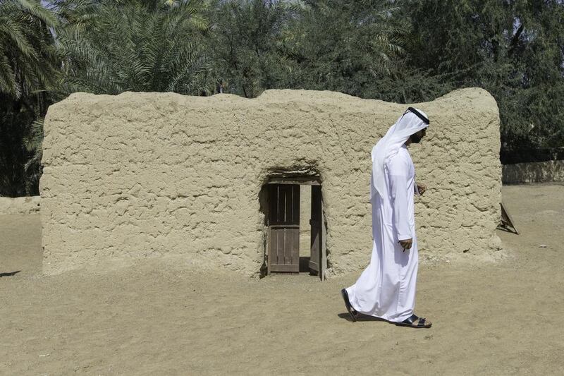 An Emirati man walks through the House of Khalfan compound in the Jimi Oasis.