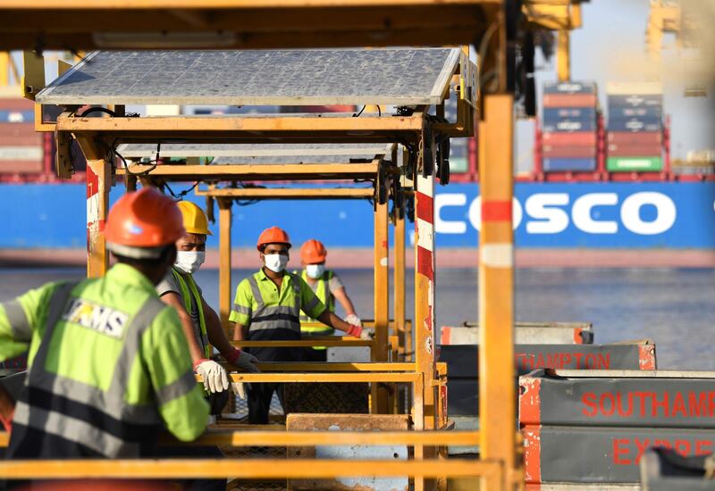 Employees wearing face masks are pictured at the port of Jebel Ali, operated by the Dubai-based ports operator DP World, in the southern outskirts of Dubai.  AFP