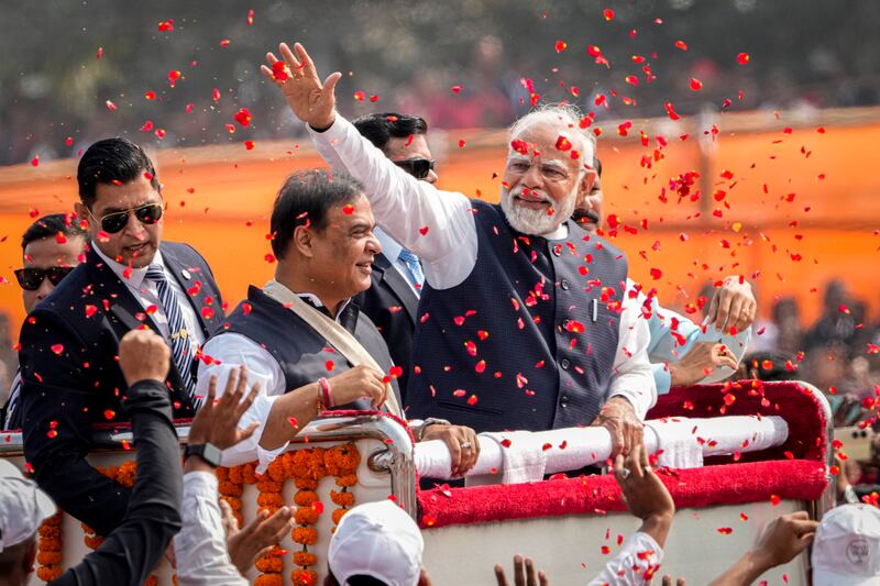Flower petals are thrown to welcome Narendra Modi to a public rally in Guwahati on February 4. AP