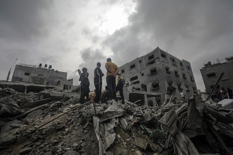Palestinians search for bodies and survivors in the ruins of a house following an Israeli air strike in Al Nusairat refugee camp, southern Gaza Strip. EPA