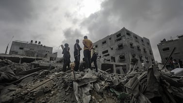 Palestinians search for bodies and survivors following an Israeli air strike in Al Nusairat refugee camp, southern Gaza Strip, on Saturday. EPA