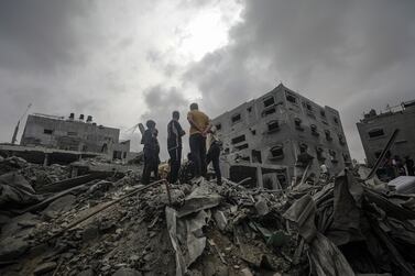 Palestinians search for bodies and survivors after an Israeli air strike in Nuseirat refugee camp, southern Gaza, on Saturday. EPA