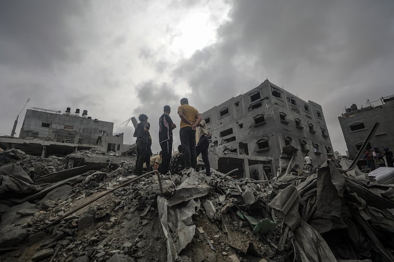 Palestinians search for bodies and survivors in the ruins of a house following an Israeli air strike in Al Nusairat refugee camp, southern Gaza Strip, on Saturday, April 27. EPA