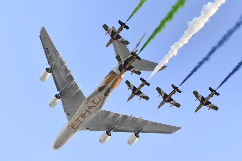 Aermacchi MB-339 jets from UAE's Al-Fursan display team perform with an Airbus A380 from Etihad Airways before the start of the Abu Dhabi Formula One Grand Prix at the Yas Marina circuit on November 26, 2017. (Photo by Andrej ISAKOVIC / AFP)