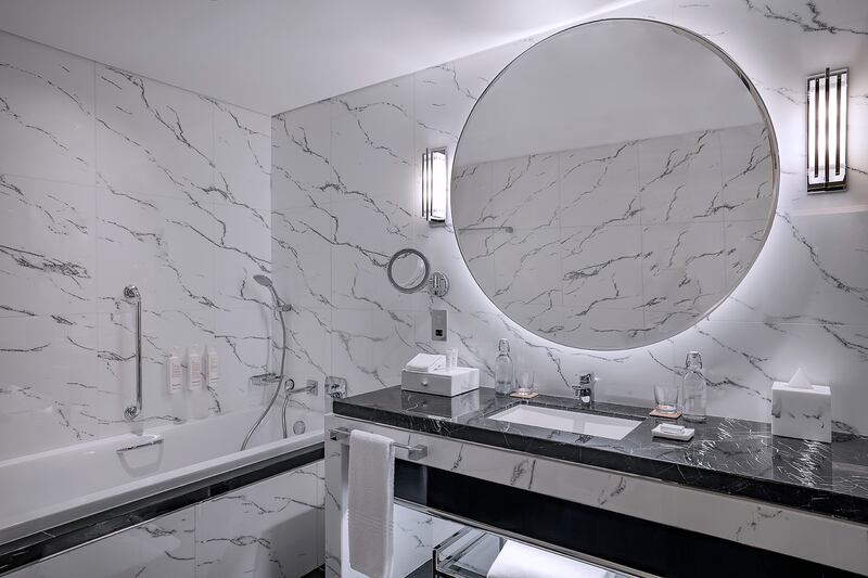 Sleek marble bathrooms with walk-in showers