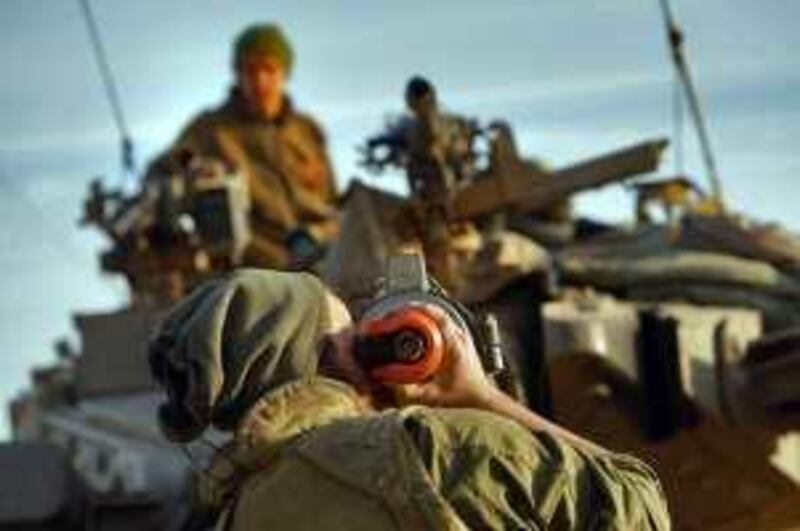 GAZA BORDER, ISRAEL - JANUARY 14:  An Israeli soldier adjusts the sites through the barrel of his tank as his unit prepares for further military action on their return from fighting Hamas militants in the nearby Gaza Strip on January 14, 2009 at an advance deployment area on Israel's border with the Palestinian territory. Israel is intensifying its wide-scale ground assault against the Gaza Strip in an effort to put an end to Hamas rocket attacks against the Jewish State.  (Photo by David Silverman/Getty Images)