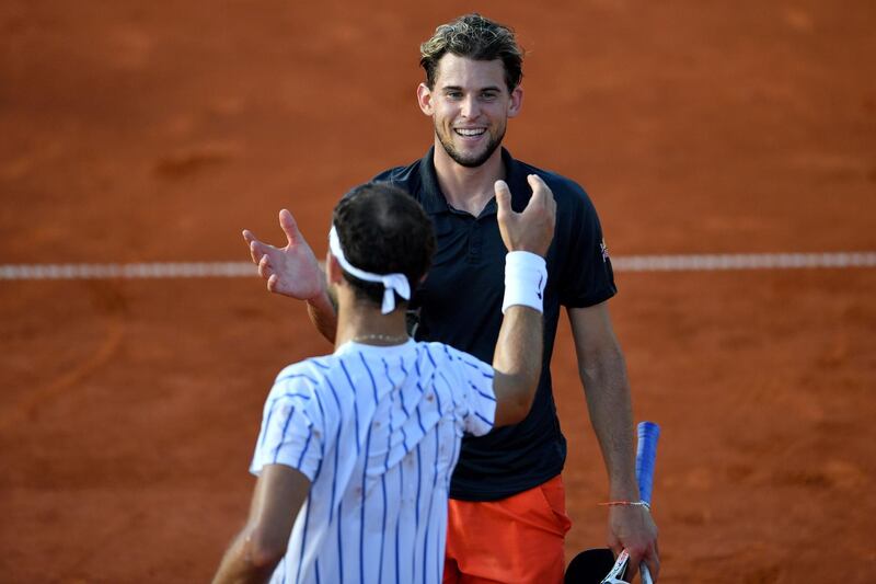 Grigor Dimitrov, facing camera, shakes hands with Dominic Thiem at the end of their match at the Adria Tour. AFP