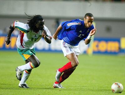 SEOUL - MAY 31:  Thiery Henry of France (right) is pursued by Ferdinand Coly of Senegal during the second half of the France v Senegal Group A, World Cup Group Stage match played at the Seoul World Cup Stadium, Seoul, South Korea on May 31, 2002. Senegal won the game 1 - 0. (Photo by Ben Radford/Getty Images)