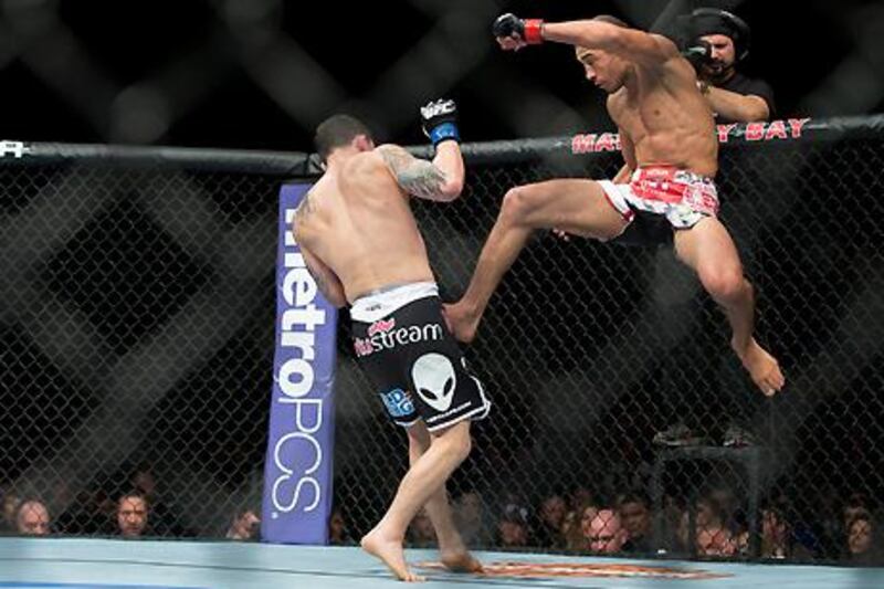 Jose Aldo throws a flying kick at Frankie Edgar during their UFC featherweight title bout.