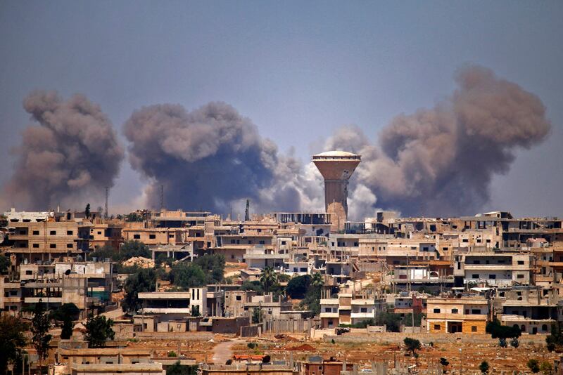 Smoke rises above rebel-held areas of the city of Deraa during reported air strikes by Syrian regime forces in 2018.  Since hostilities resumed in July, civilians have witnessed intense fighting and indiscriminate shelling. AFP