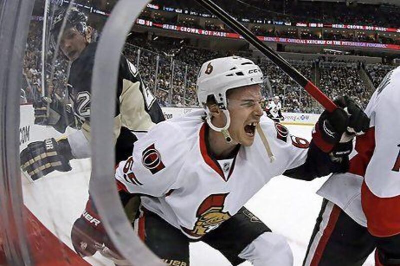 Pittsburgh Penguins enforcer Matt Cooke, left, says he had no intention of injuring Ottawa Senators defenseman Erik Karlsson, but Karlsson is now out indefinitely after one of Cooke's skates cut an achilles tendon on Karlsson.