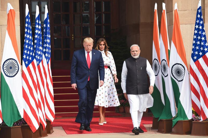 India's Prime Minister Narendra Modi walks with US President Donald Trump and First Lady Melania Trump before a meeting at Hyderabad House in New Delhi. AFP