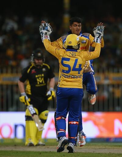 SHARJAH, UNITED ARAB EMIRATES - DECEMBER 14: Mujeeb Zadran and Sarfraz Ahmed of Bengal Tigers celebrates the wicket of  Eoin Morgan of Kerela Kingsduring the T10 League match between Bengal Tigers and Kerala Kings at Sharjah Cricket Stadium on December 14, 2017 in Sharjah, United Arab Emirates.  (Photo by Francois Nel/Getty Images)