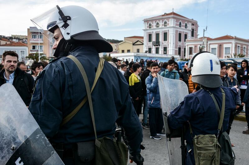 Greek police in riot gear stand before minor clashes with migrants at the port of Mytilene on the northeastern Aegean island of Lesbos, Greece. AP Photo