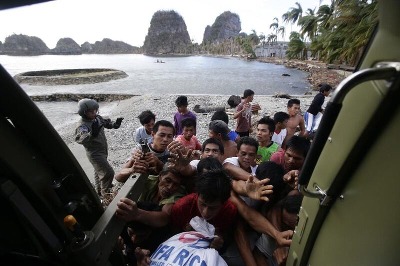 Filipino typhoon victims rush to receive aid transported by the Philippine Air Force Sokol 550th Search and Rescue Group in a typhoon devastated remote village in eastern Samar province, Philippines. Dennis Sabangan/EPA