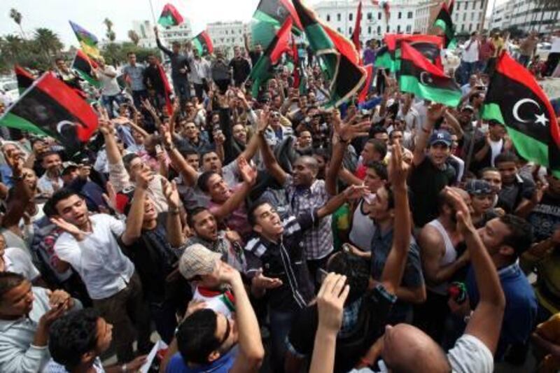 Residents celebrate at Martyrs square in Tripoli October 20, 2011 after hearing the news that former leader Muammar Gaddafi was killed in Sirte. Gaddafi died in an attack by NTC fighters, a senior NTC official said on Thursday. REUTERS/Ismail Zitouny (LIBYA - Tags: POLITICS CIVIL UNREST) *** Local Caption ***  SJS05_LIBYA-_1020_11.JPG