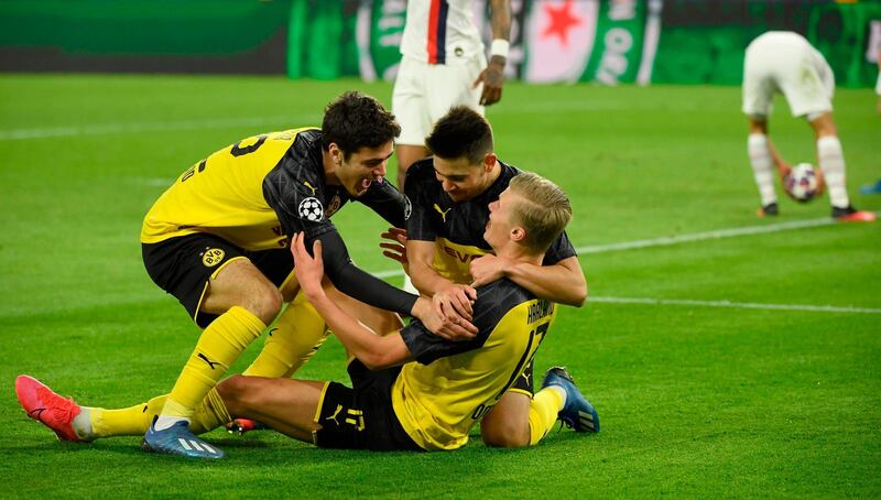 Dortmund forward Erling Haaland is congratulated by  teammates Giovanni Reyna and Raphael Guerreiro after giving his side the lead against PSG.  AFP