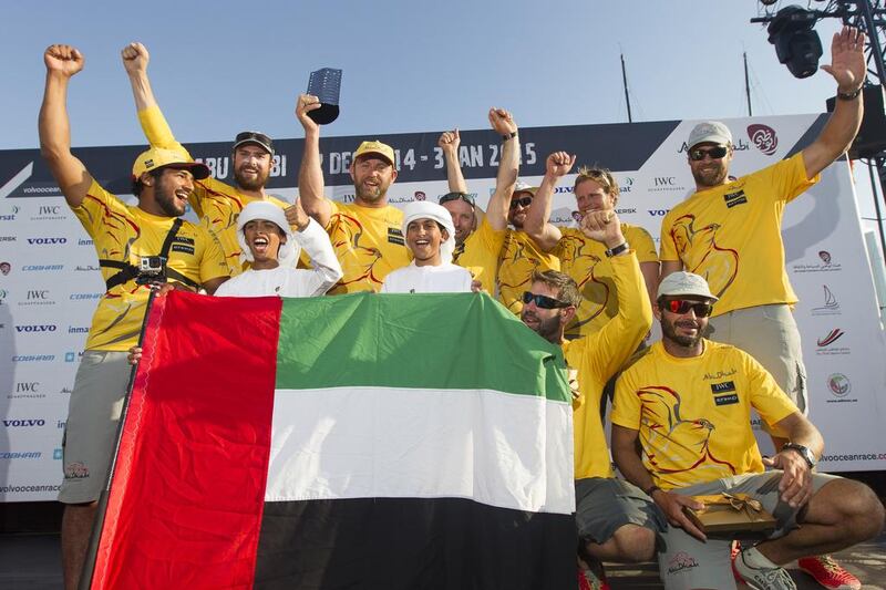 Abu Dhabi Ocean Racing crew pose with the UAE flag on Saturday after arriving in Abu Dhabi to complete the Volvo Ocean Race's second leg. Ian Roman / Abu Dhabi Ocean Racing