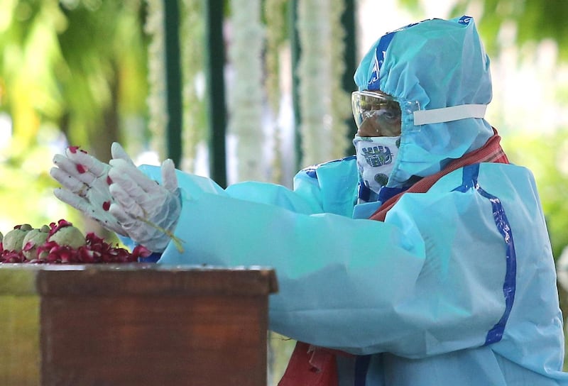 Mukherjee had tested positive for Covid-19 and had been through brain surgery. Here, his son Abhijit Mukherjee pays floral tributes before his cremation at Lodhi road crematorium in New Delhi. EPA