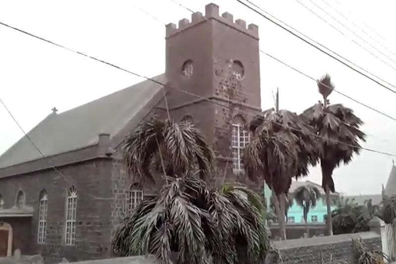 Ash covers palm trees and a church in the town of Georgetown, about eight kilometres from the La Soufriere volcano. Reuters