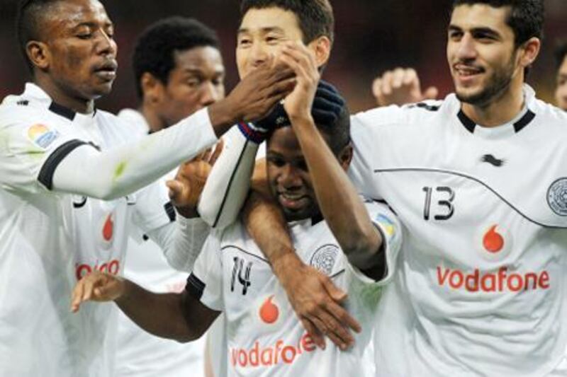 Al Sadd's Khalfan Al Khalfan (C) celebrates his goal with teammates during their quarter-final football match against against Esperance at the Club World Cup in Toyota, Aichi prefecture on December 11, 2011. Qatar's Al Sadd beat Esperance 2-1.   AFP PHOTO / TOSHIFUMI KITAMURA

