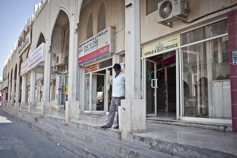 A man stands outside a shop. Three decades ago, Msheirib and its South Asian merchants were the commercial centre of a sleepier Doha. Some of the first international hotel chains in the capital opened here, and residents used to shop at furniture shops and mini-shopping centres here that have been overtaken by newly built and glitzy mega-malls springing up elsewhere in the city.