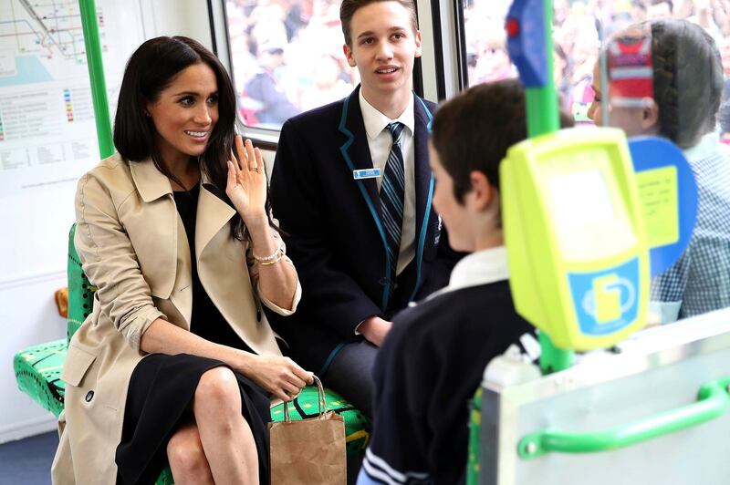 Meghan chats to students on the tram. AP Photo