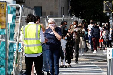 Britons queue outside a coronavirus testing site in Bolton. Reuters