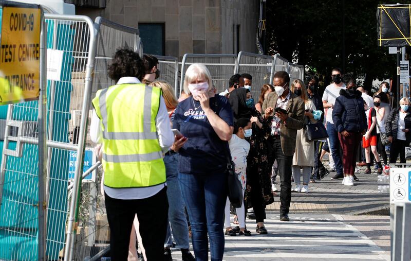 People queue outside a test centre to take a coronavirus test amid the coronavirus disease (COVID-19) outbreak, in Bolton, Britain, September 17, 2020. REUTERS/Phil Noble