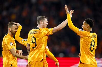 Wout Weghorst of Netherlands, centre, celebrates with teammates after scoring against Republic of Ireland. EPA