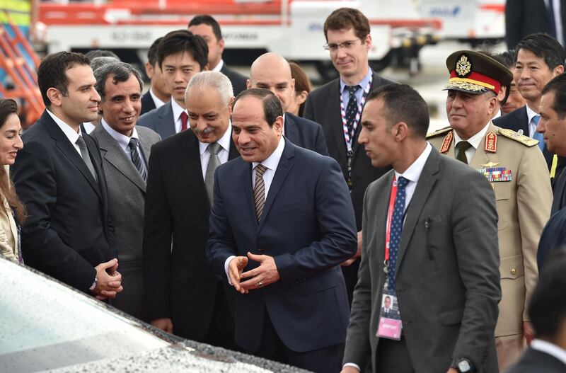 Mr El Sisi is greeted by Japanese officials. AFP