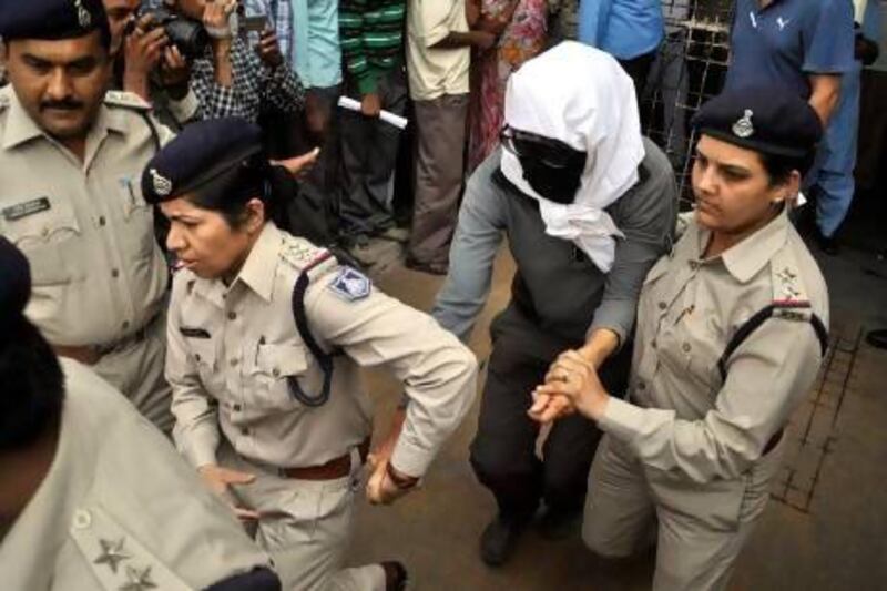 A Swiss rape victim is escorted by policewomen for a medical examination at a hospital at Gwalior in the Indian state of Madhya Pradesh.