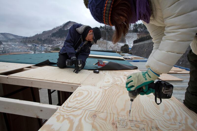 Carpenter Maya Ito, left, and Hiroko Kouchi, both volunteers of Peace Boat Disaster Relief Volunteer Center, build roof of local shopping center in Onagawa in Miyagi prefecture in Japan on Feb 29, 2012. Thousands of volunteers, including with the Peace Boat, have been helping to rebuild the town which was swept away by the massive tsunami hit northern Japan on March 1, 2011.
Photo by Kuni Takahashi